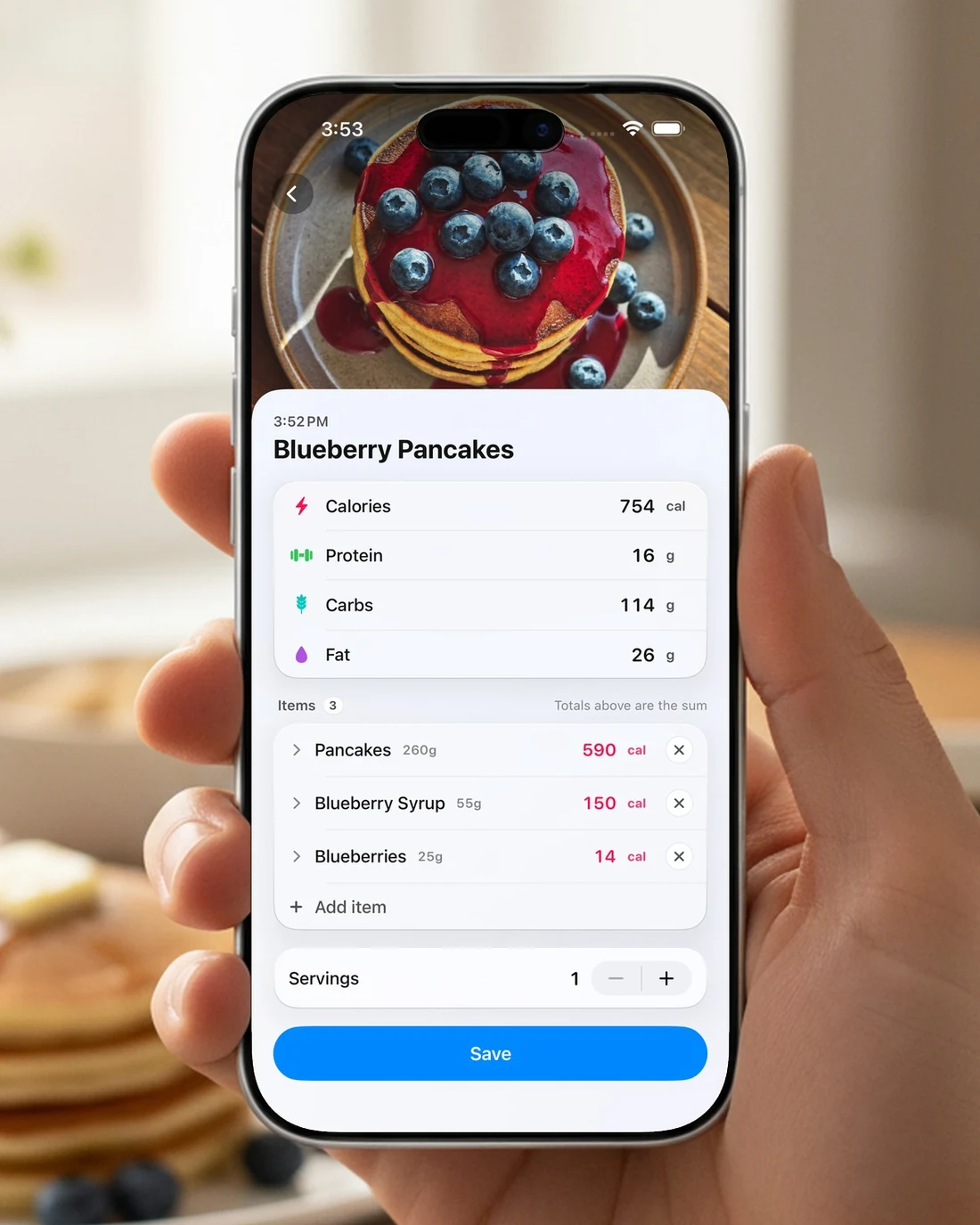 A hand holding an iPhone showing a scanned plate of pancakes broken down into ingredients