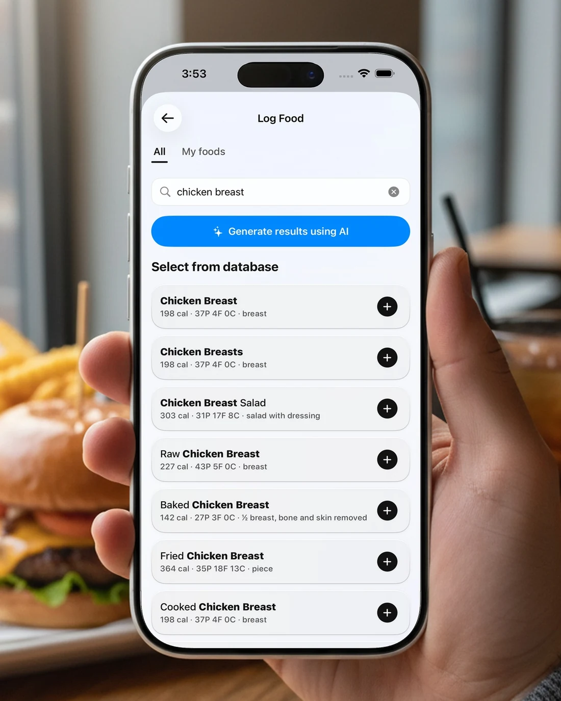 A hand holding an iPhone showing food search results for chicken breast